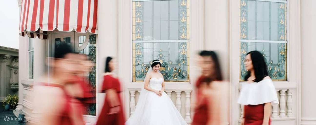 Woman in bridal dress in front of store